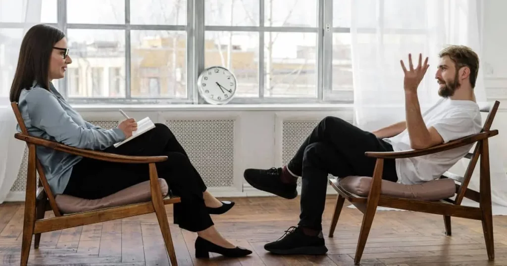 A man talking to a therapist during a counseling session to understand anxiety
