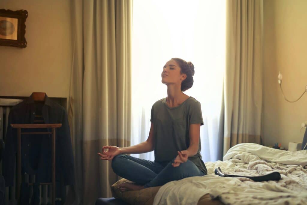 Woman practicing meditation for calm mind and mental clarity.